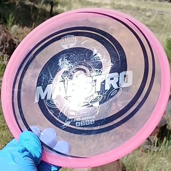 040102.03 Maestro Double Spiral disc golf midrange with custom geometric design. Pink disc with black spirals.