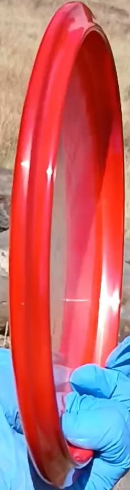 88010301.01 Fuzion Fugitive Orbit Red Blank disc golf midrange Special Edition from Dynamic Discs. profile wing view.