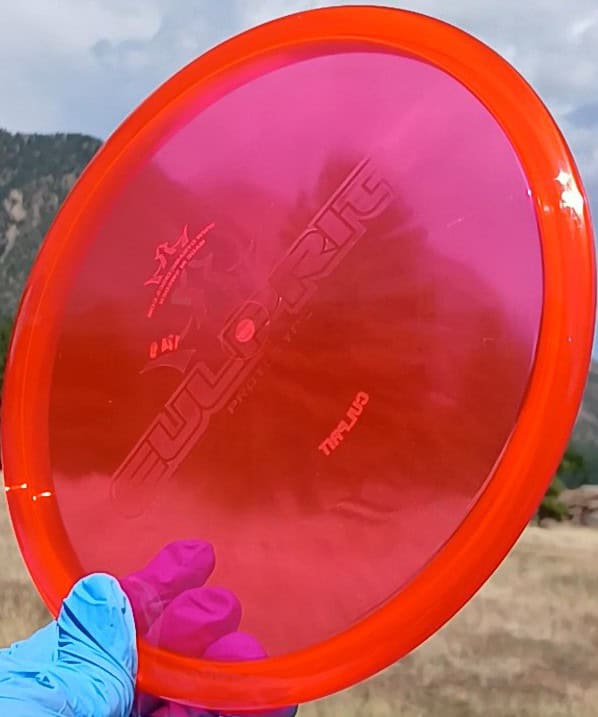 88011210.01 Lucid Ice Culprit Red Wiped Proto overstable disc golf midrange/putter hybrid from Dynamic Discs. ghost stamp wiped disc front tilt view