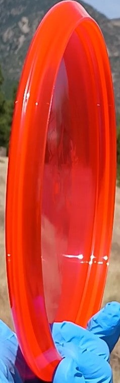 88011210.01 Lucid Ice Culprit Red Wiped Proto overstable disc golf midrange/putter hybrid from Dynamic Discs. ghost stamp wiped disc profile wing view.
