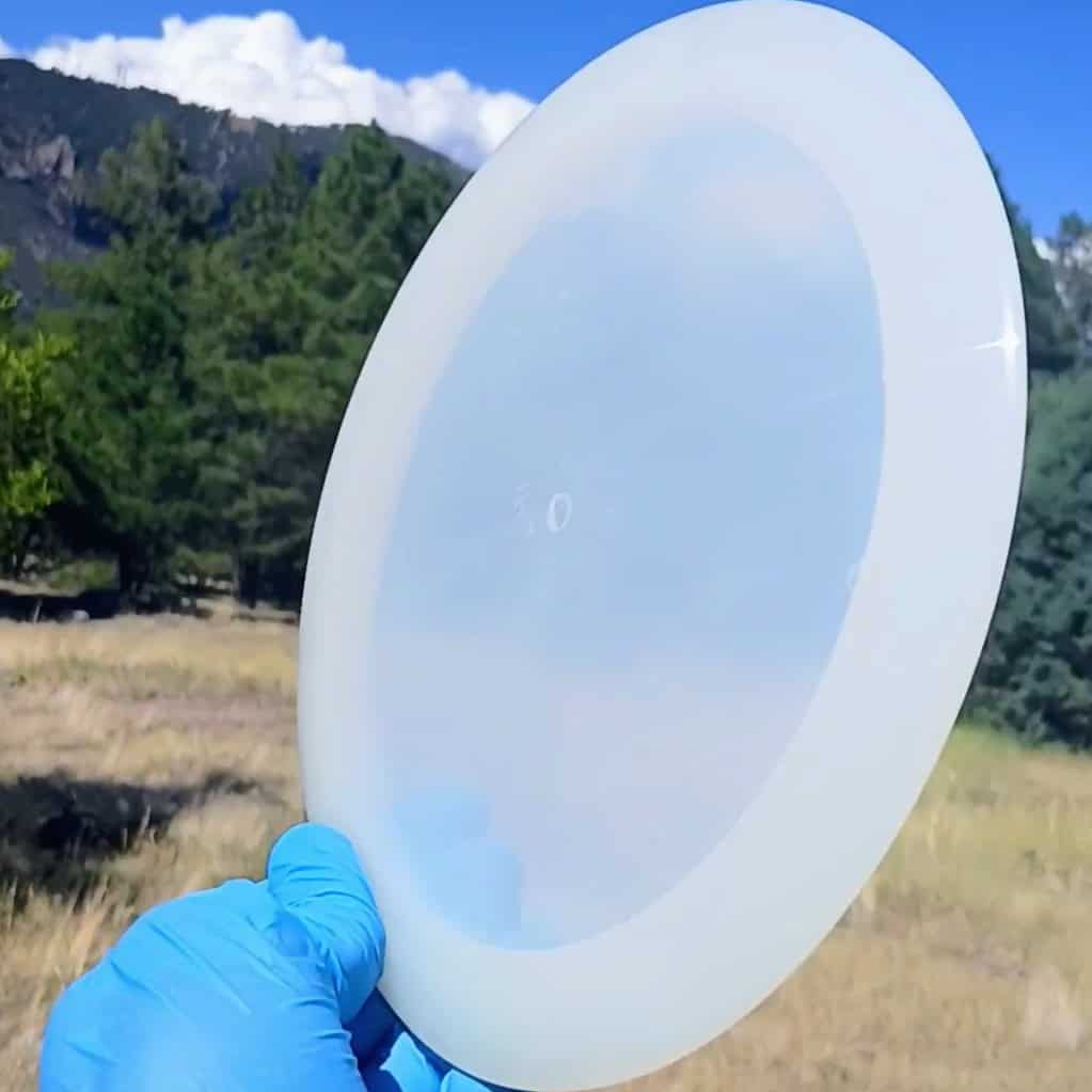 88014210.03 Lucid Ice Defender white blank overstable disc golf distance driver from Dynamic Discs. front uncropped tilt view