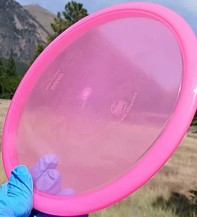 88040101.08 Active Premium Tailor pink wiped overstable disc golf midrange from Discmania. front tilt view