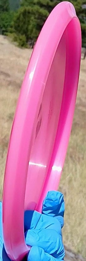 88040101.08 Active Premium Tailor pink wiped overstable disc golf midrange from Discmania. profile wing view