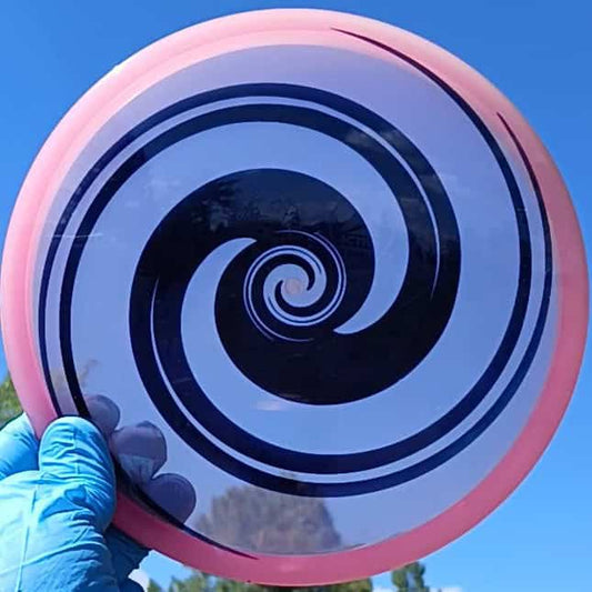 040102.03 Maestro Double Spiral disc golf midrange with custom geometric design. Pink disc with black spirals.
