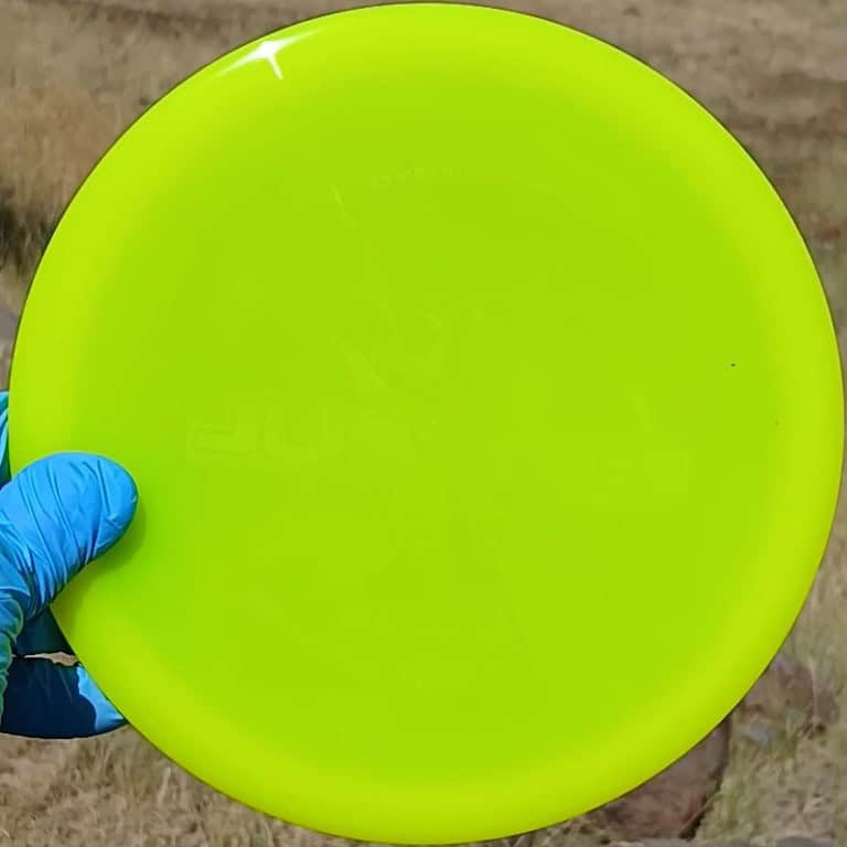 8801402.02 Lucid Justice yellow disc golf overstable midrange from Dynamic Discs. Wiped ghost stamp front view