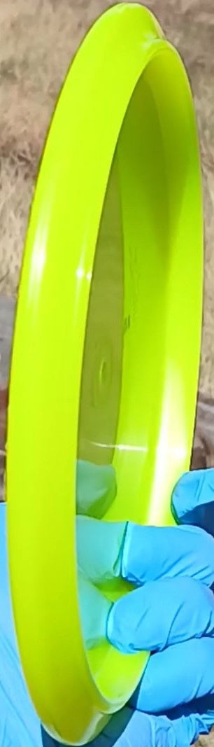 8801402.02 Lucid Justice yellow disc golf overstable midrange from Dynamic Discs. Wiped ghost stamp profile wing view