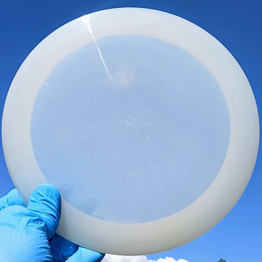 88014210.03 Lucid Ice Defender white blank overstable disc golf distance driver from Dynamic Discs. front skyline view