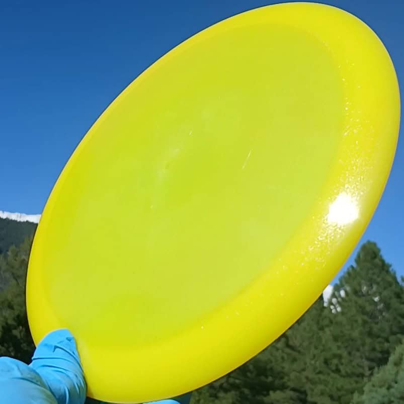 88014703.12 Lucid Air Renegade yellow disc golf distance driver from Dynamic Discs. front tilt view