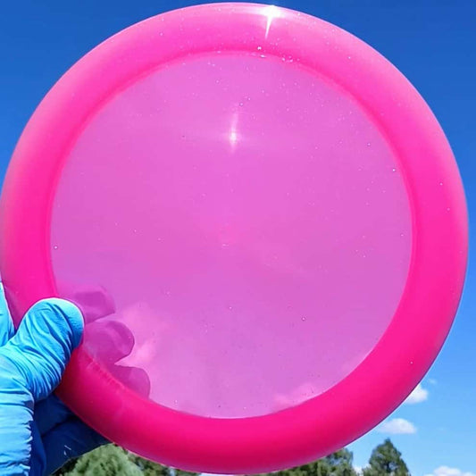 88024002.04 Opto Sparkle Ballista pink blank disc golf distance driver from Latitude 64. front view skyline