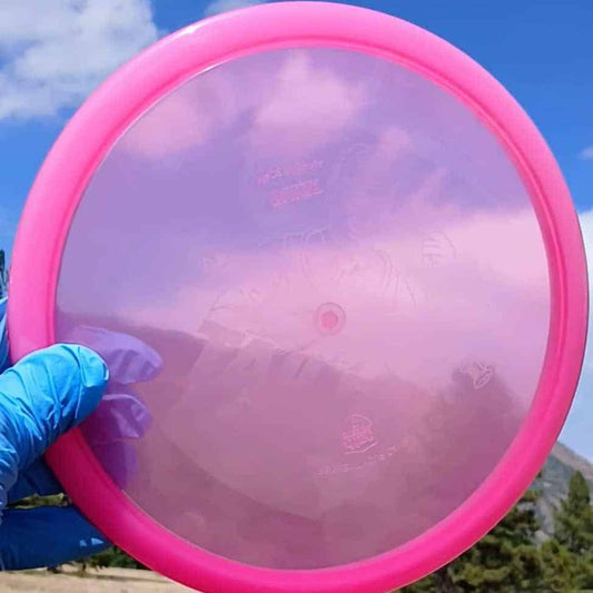 88040101.08 Active Premium Tailor pink wiped overstable disc golf midrange from Discmania. front sky view