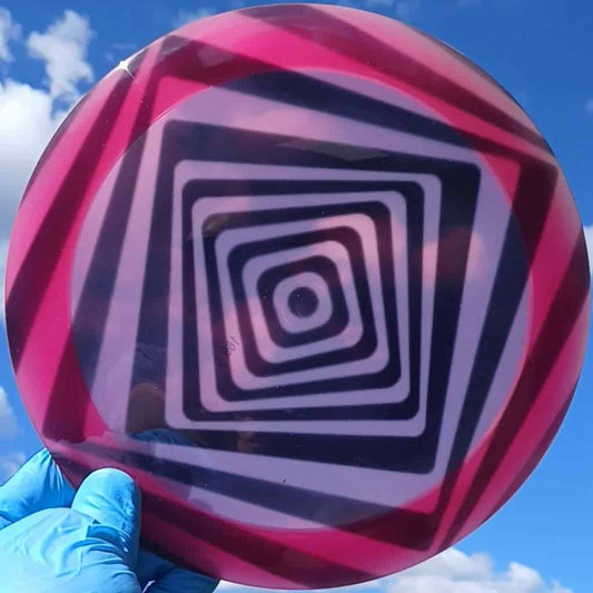 Westside Discs VIP Queen Spiral Square custom dyed distance driver pink and black geometric pattern front sky view