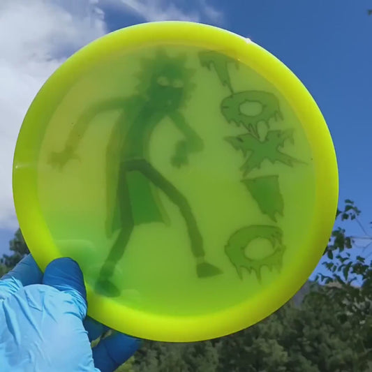 010902.11 Lucid Emac Truth Toxic Rick disc golf midrange. Yellow disc with green Rick & Morty.