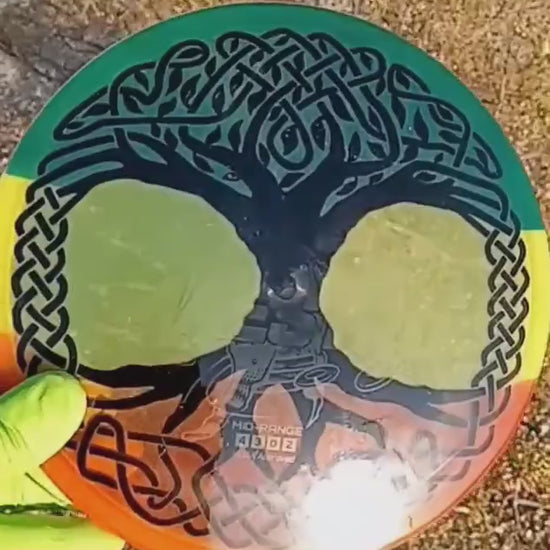 040102.22 Maestro Celtic Tree of LIfe disc golf midrange from Discmania. Yellow disc with red and green dyed patterns for a rasta effect.