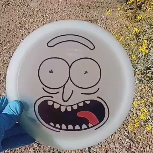 Discmania Active Premium Glow Rockstar with Rick and Morty design. Glow-in-the-dark fairway driver shown in a desert scenario in the daytime.
