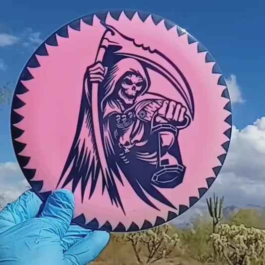 014701.01 Fuzion Sergeant Grim Reaper disc golf distance driver from Dynamic Discs. Pink disc with black design and flared border.