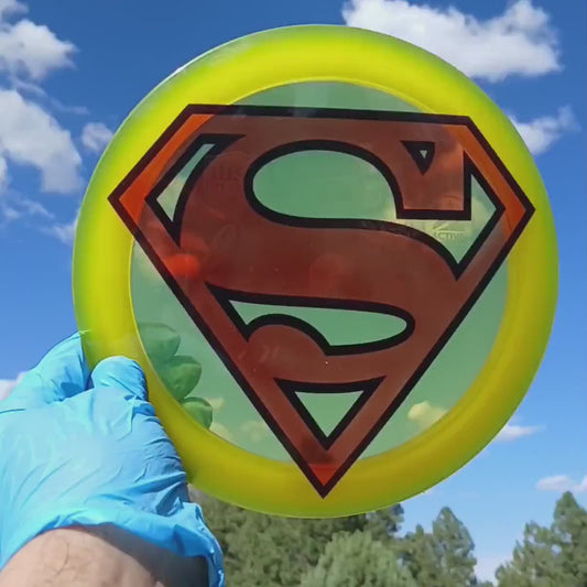 044102.08 Premium Astronaut Superman black and red custom disc golf design on bright yellow Discmania Active Premium Astronaut.
