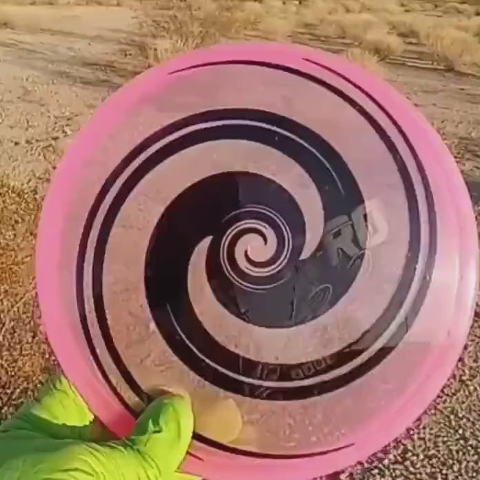 040102.03 Maestro Double Spiral disc golf midrange with custom geometric design. Pink disc with black spirals.