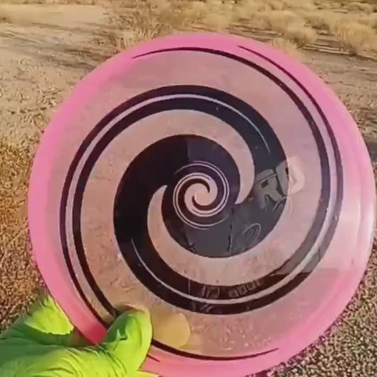 040102.03 Maestro Double Spiral disc golf midrange with custom geometric design. Pink disc with black spirals.