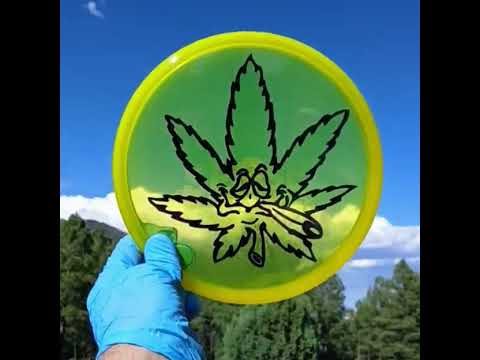 Discmania Sensei yellow Cannabis Carl disc golf putter from Discmania. Stencil dye green amd black on yellow disc.