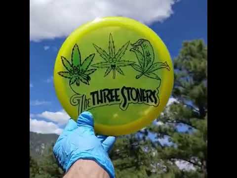 Discmania Genius with The Three Stoners cannabis design on yellow disc with green and black dye.